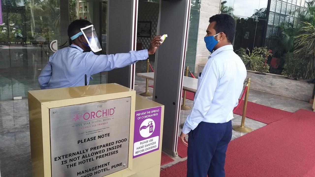 The Orchid Hotel Hinjewadi Пуне Екстер'єр фото Temperature check at the entrance of a hotel in India